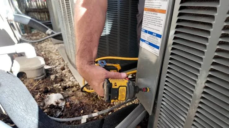 Technician using specialized tools for urgent outdoor AC repair